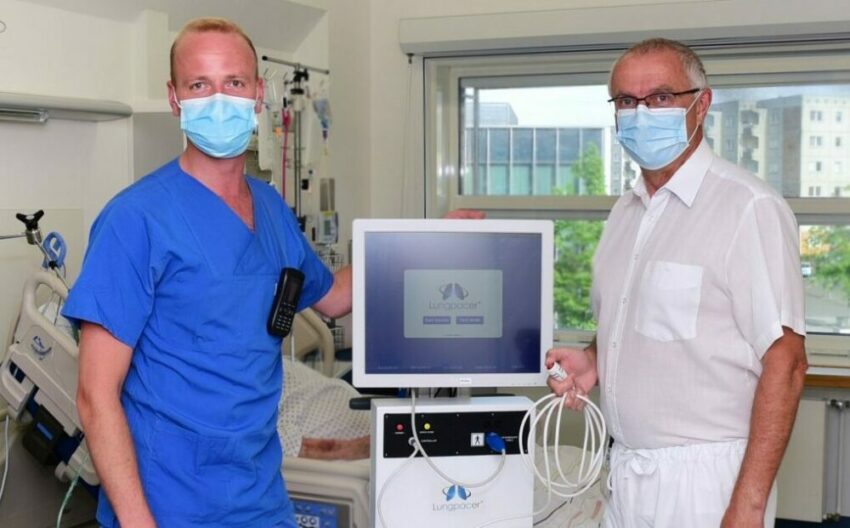 Doctors standing in front of lungpacer machine and treated patient